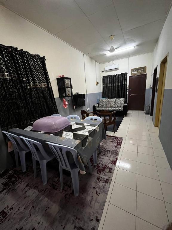 a living room with a bed and a couch at Homestay Seri Aishah in Chemor