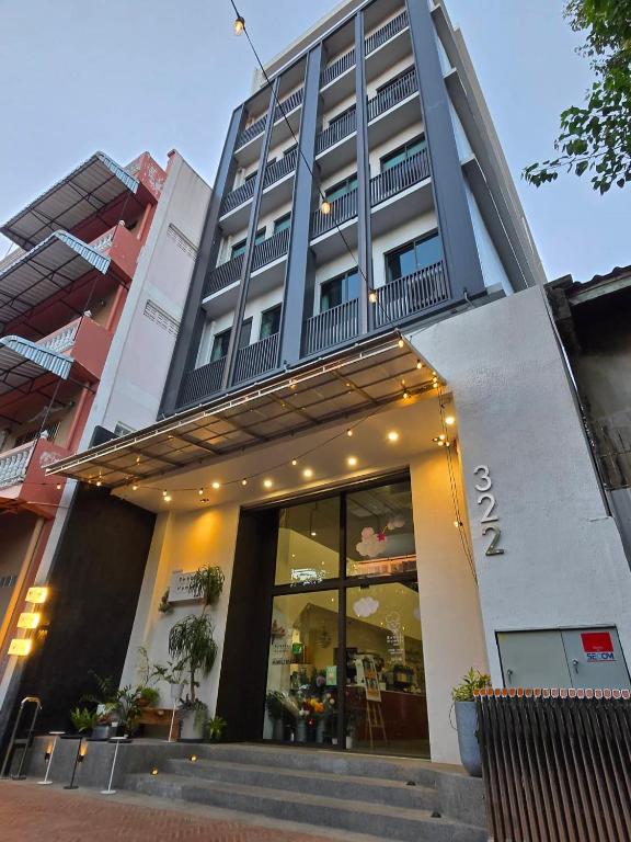a building with a store front with a balcony at Bubble Humble Bangkok By Canal in Bangkok