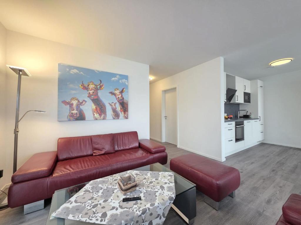 a living room with a couch and a table at Ferienwohnung NorderHafen in Norden