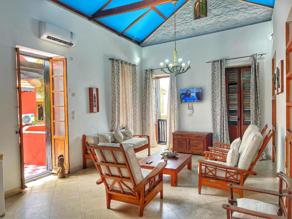 a living room with a couch and a table and chairs at Résidence Soros - Île de Gorée in Dakar