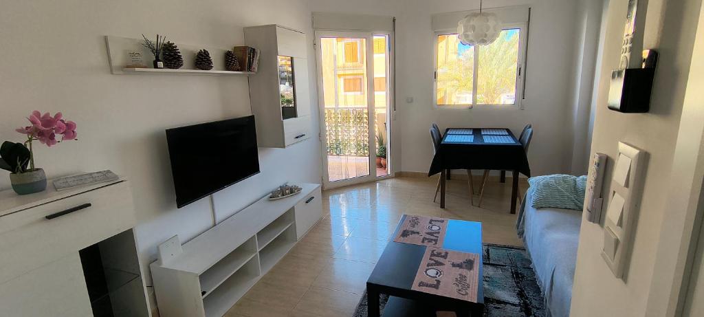 a living room with a couch and a tv at Casa Dolores in Puerto de Mazarrón