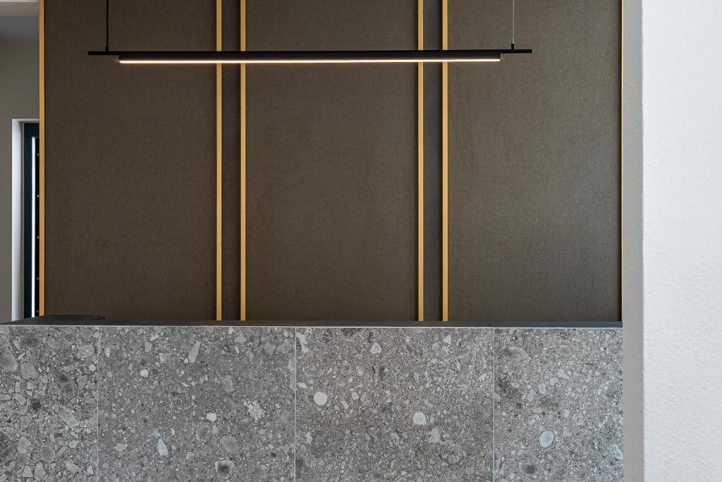 a kitchen with brown and gold cabinets at Opulence12 Suites in Karpathos