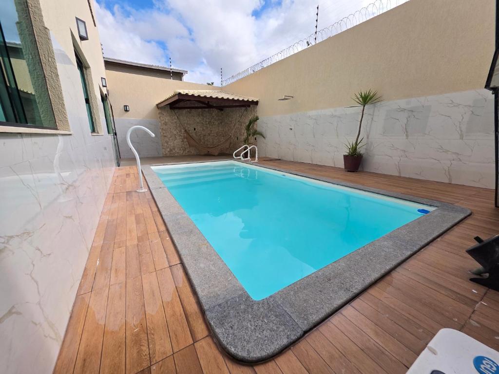 a swimming pool in the middle of a house at Inocoop house in Camaçari