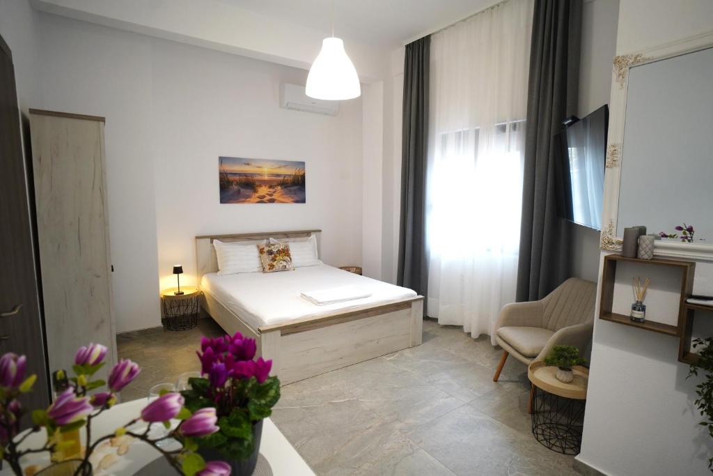 a small room with a bed and a couch at AsproLux Seaside Studios in Asprovalta