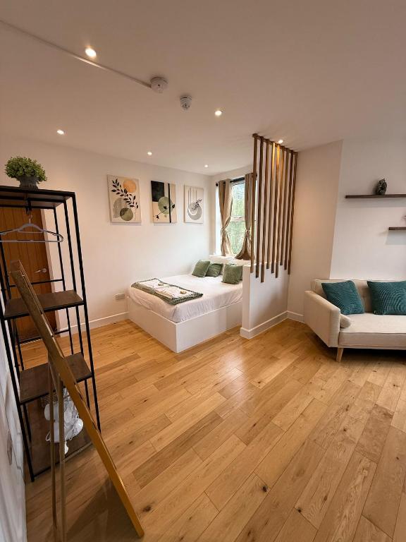 a living room with a bed and a couch at The Kove Oceanview in Bournemouth