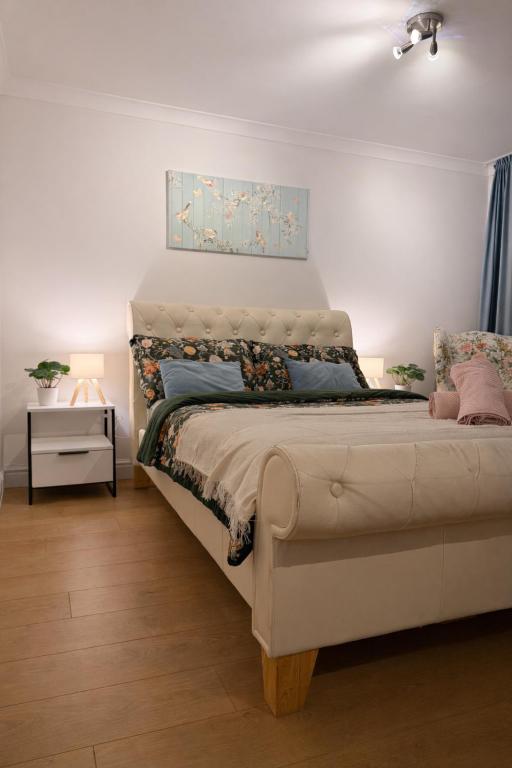 a bedroom with a bed with a painting on the wall at Spacious Double Room in Shared Flat in Sutton