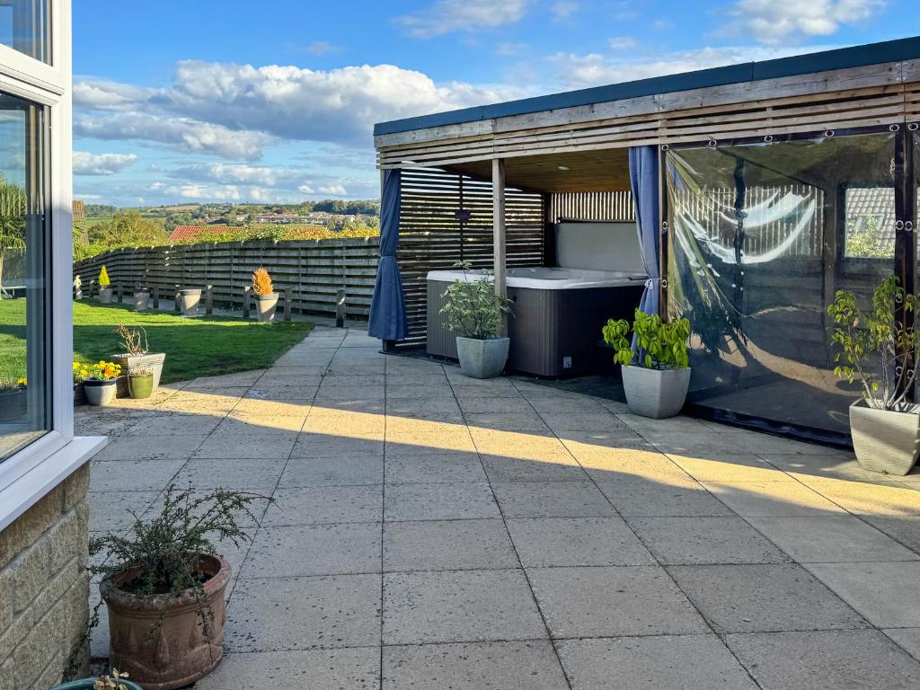 a patio with a shower and a bath tub at Little Nauvoo in Bath