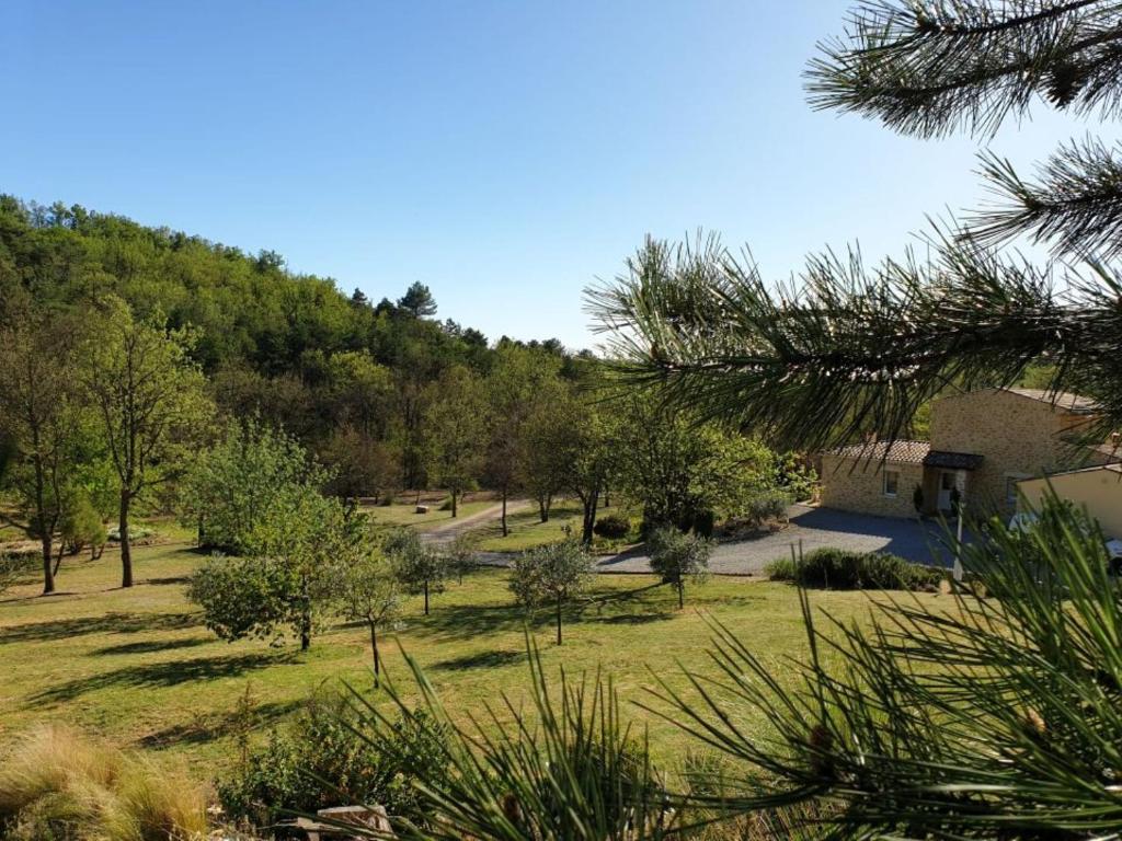 a view of a park with trees and a building at Domaine De JI in Montagnac