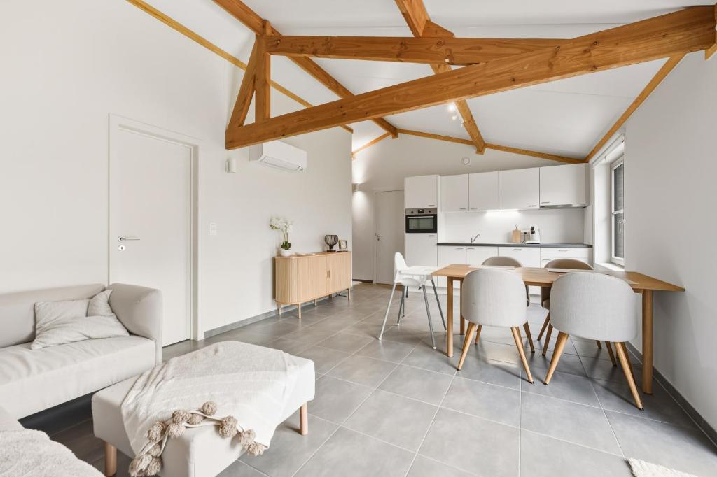 a living room with a couch and a table at Duinhuis 20 P in Oostduinkerke