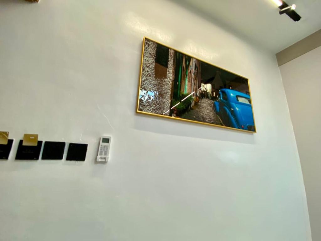 a television hanging on a wall in a room at Ghomes in Lagos