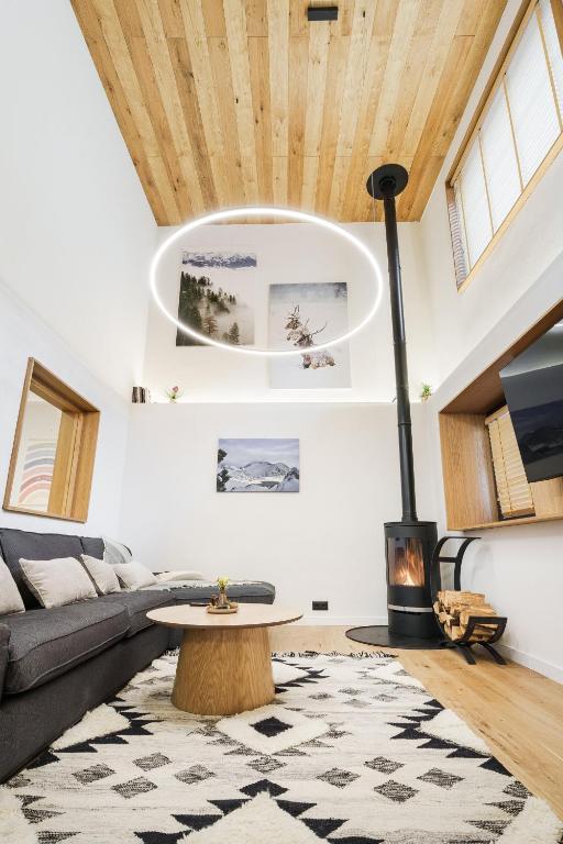 a living room with a couch and a fireplace at Chalet Charm - Private Mountain Retreat with Sauna, Jacuzzi & Kids Playroom in Bansko