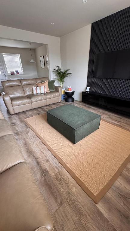 a living room with a couch and a coffee table at No 67 West Road in Fraserburgh