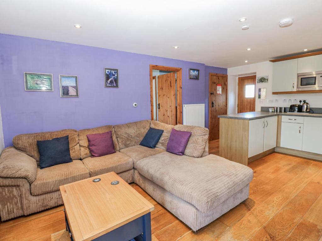 a living room with a couch and a table at Swallows Rest in Hexham