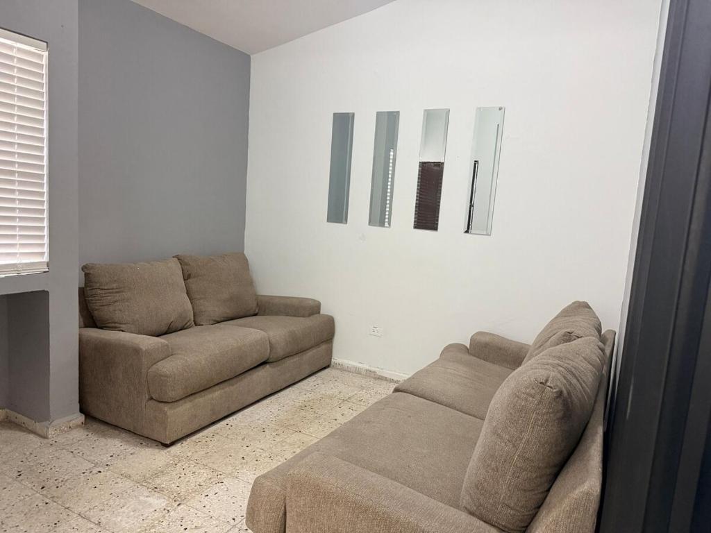 a living room with a couch and a chair at Colorín RB in La Paz