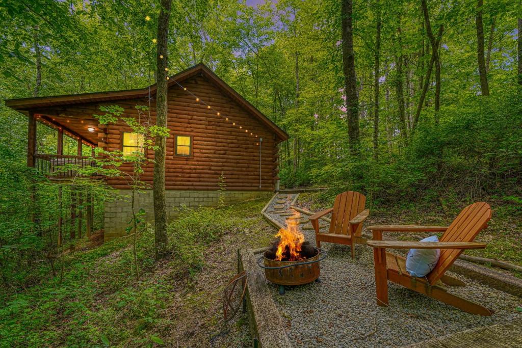 a fire pit in front of a log cabin at Havenridge in Logan