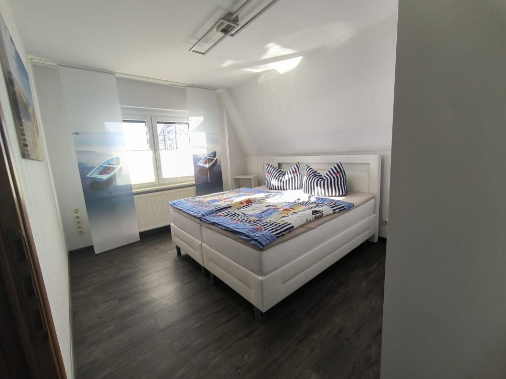 a bedroom with a bed with striped pillows on it at Leuchtturmhus in Fürstenberg