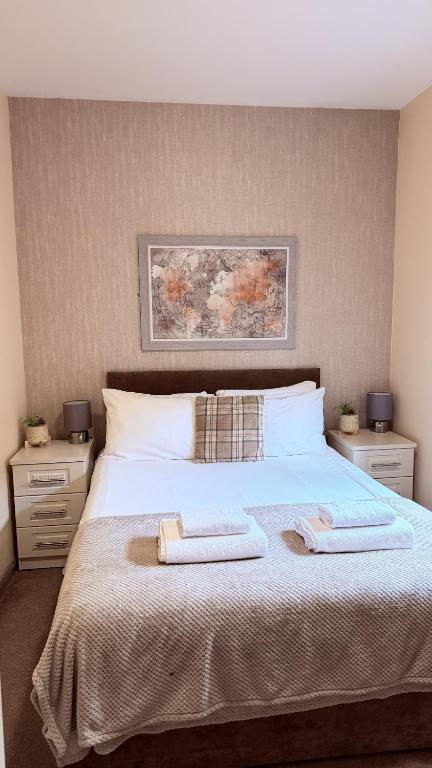 a bedroom with a large bed with two towels on it at Grant House in Boston