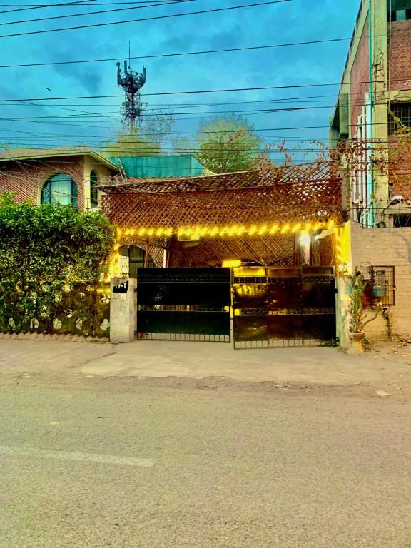 a building with a garage with lights on it at Green View Inn Hotel in Lahore