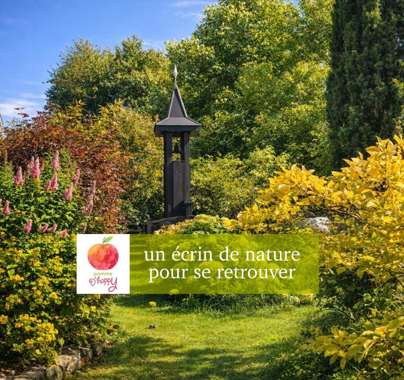 a sign in the middle of a garden at Pomme d'Happy in Autheux