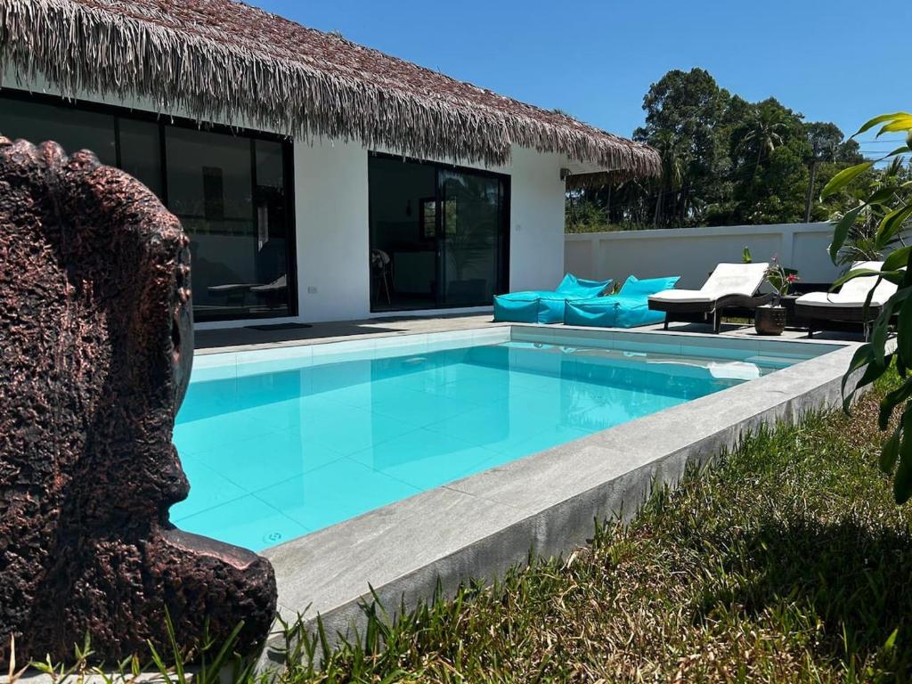 a swimming pool in front of a villa at Villa L Aurora in Taling Ngam Beach