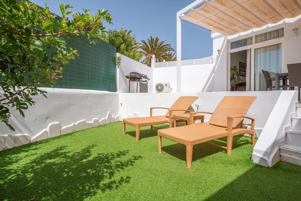 a patio with lawn chairs and a fence at Nice Bungalow with Two Bedrooms in Adeje