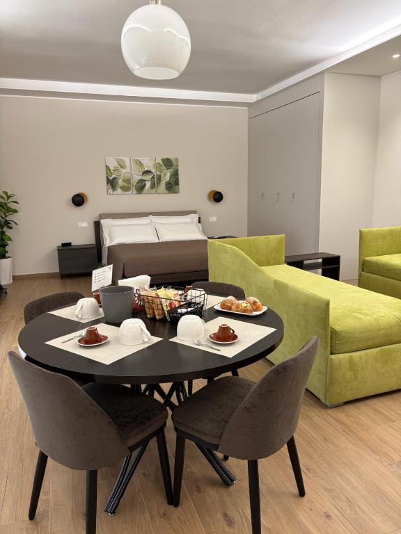 a living room with a table and a couch at Sogni in Suites in Bari