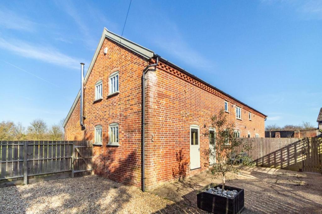 a brick building with a tree in front of it at 3 Bed in Knodishall oc-wbco in Aldringham