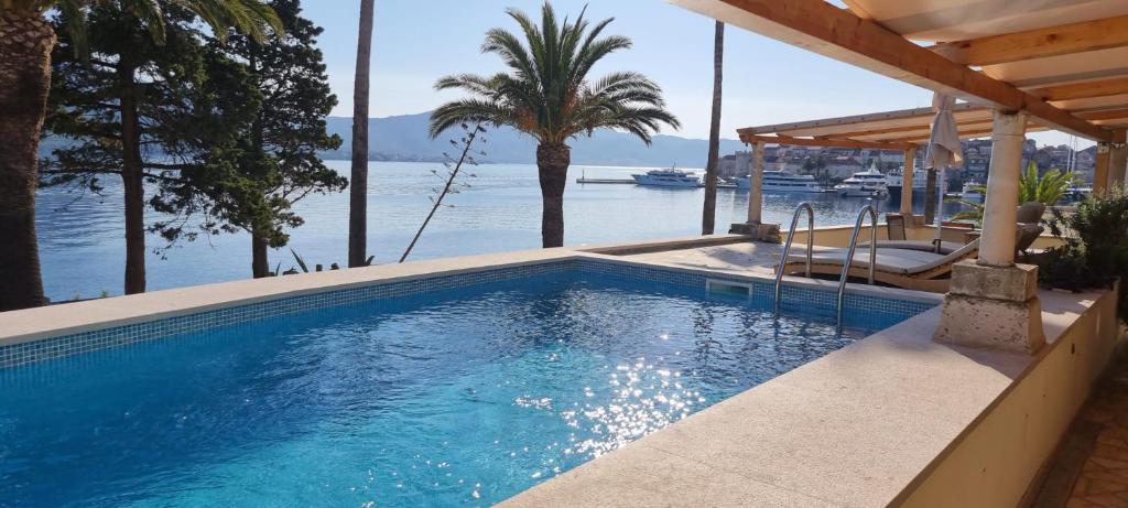 a swimming pool with a view of the water at Infinity Blue Korčula in Korčula