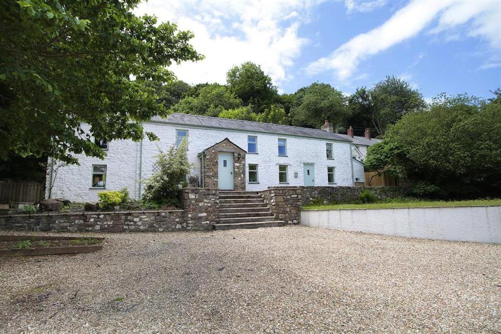 a large white house with a stone driveway at 4 Bed in Gower oc-hh471 in Llanmadoc