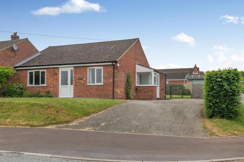 a brick house with a driveway in front of it at 2 Bed in Reedham oc-2378 in Haddiscoe
