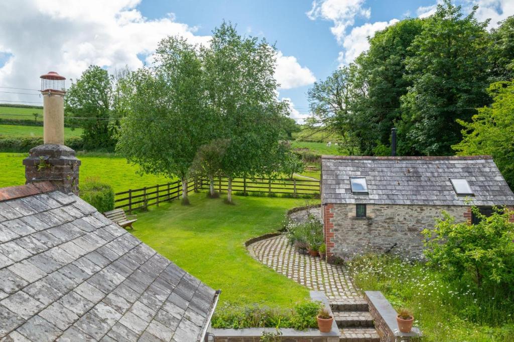 an image of two old stone buildings in a field at 4 Bed in St. Wenn oc-p00886 in Saint Wenn