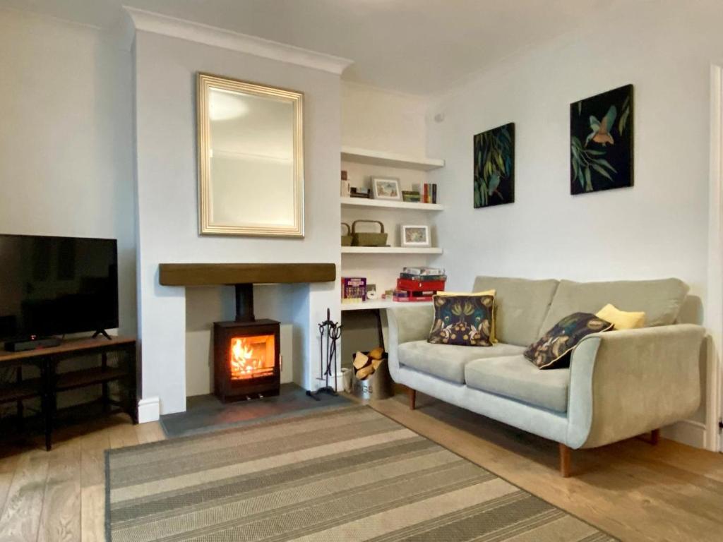 a living room with a couch and a fireplace at 3 Bed in Winterton-on-Sea oc-2205 in Winterton-on-Sea