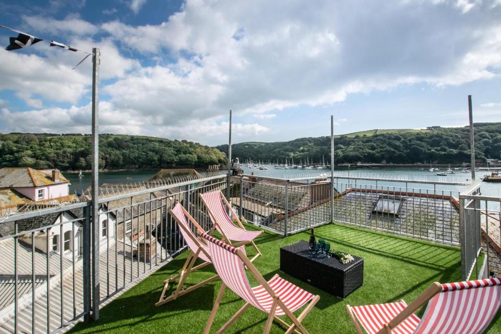two chairs on a balcony with a view of the water at 3 Bed in Fowey oc-p00647 in Fowey