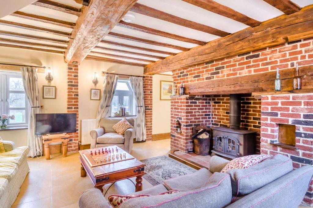 a living room with a fireplace and a brick wall at 3 Bed in Gressenhall oc-o28417 in East Dereham