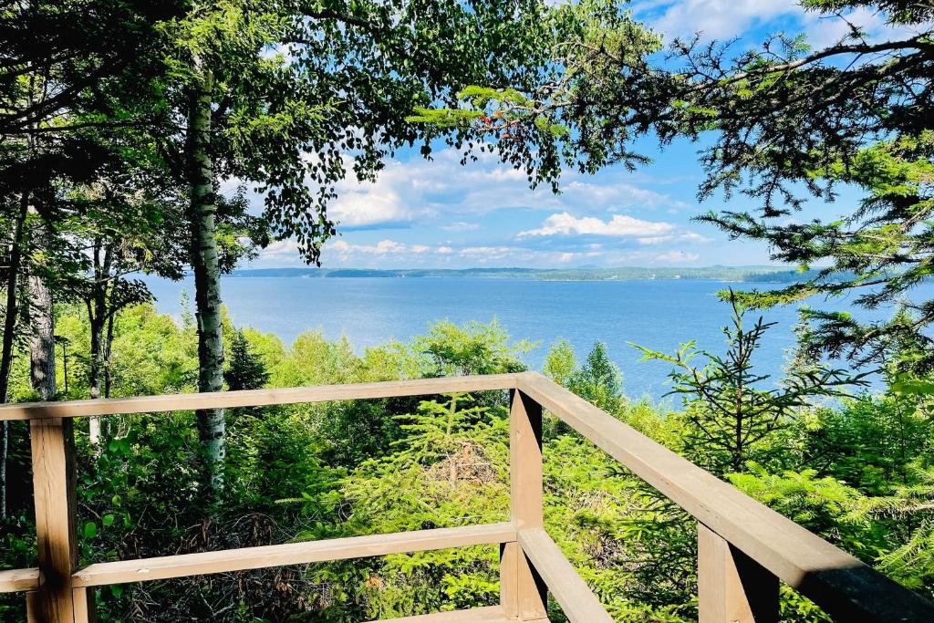 a wooden fence with a view of the water at Bay-View Getaway w/ Deck Between Camden & Belfast! in Northport