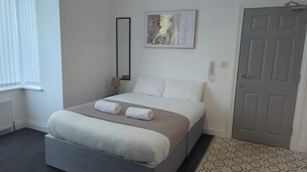 a bedroom with a bed with two pillows on it at Sunderland Stadium Studios in Sunderland