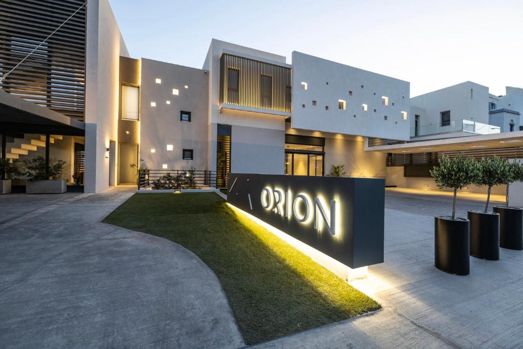 a large building with a sign that reads autism at Orion Tinos Suites in Tinos