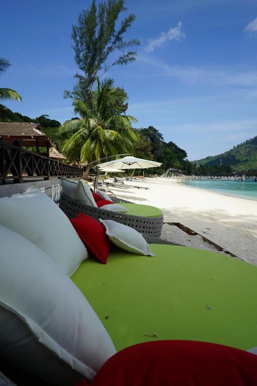 a beach with a bunch of pillows on the beach at Perhentian Island Resort in Perhentian Islands