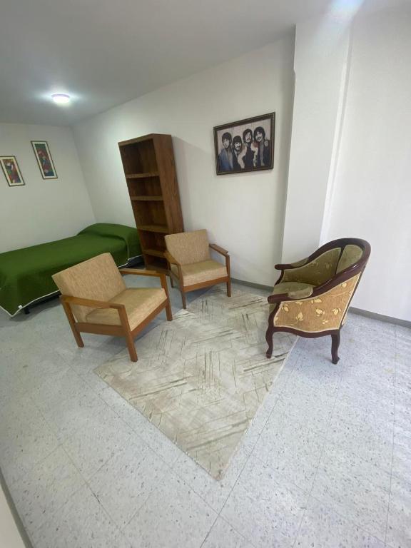 a living room with two chairs and a couch at Siéntete en casa 2 in Pasto