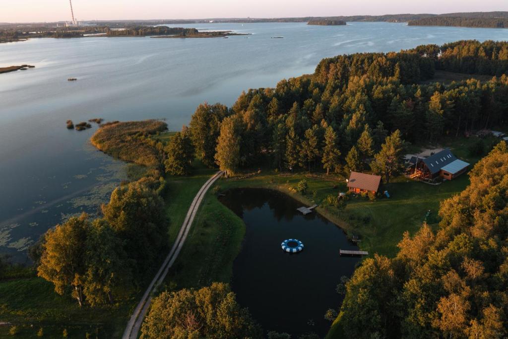 an aerial view of a house on an island in a lake at House of Sparkles in Elektrėnai