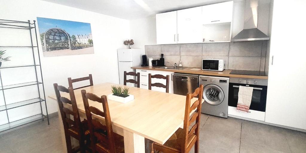 a kitchen with a wooden table and a dining room at Appartement 8pers à Vallères in Vallères