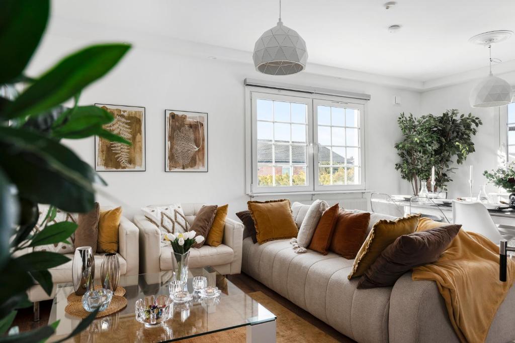 a living room with a couch and a table at Sunset Stay in Malmö