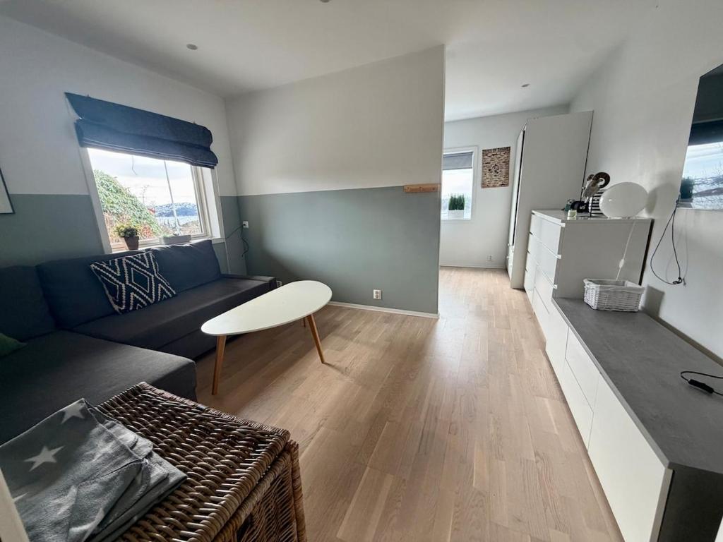 a living room with a couch and a table at Sea View apartment in Askøy