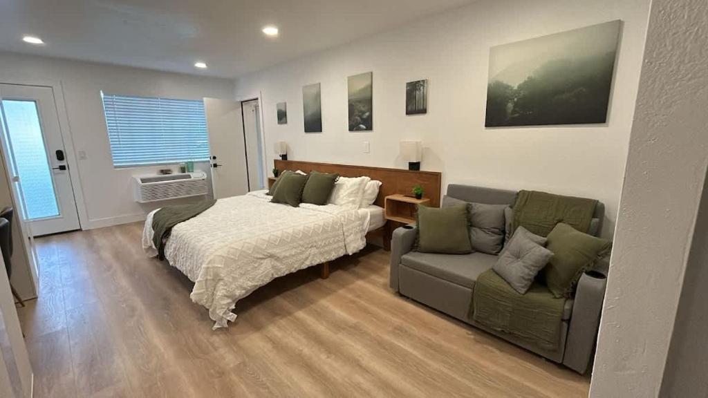 a living room with a bed and a couch at #3 Hygge Hus Hotel - King Suite Connectable in Andrews