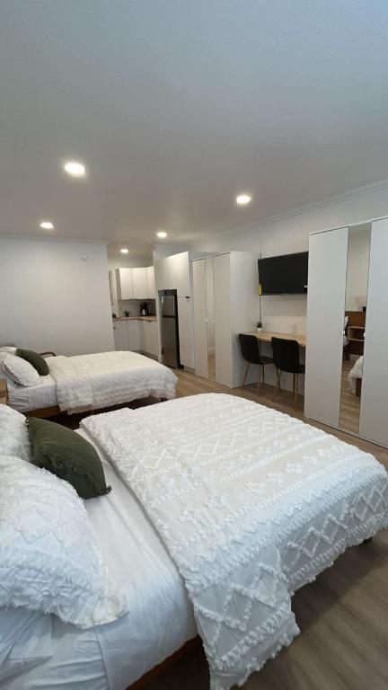 a large bedroom with two beds and a desk at #4 Hygge Hus Hotel - Double Room Suite Connectable in Andrews