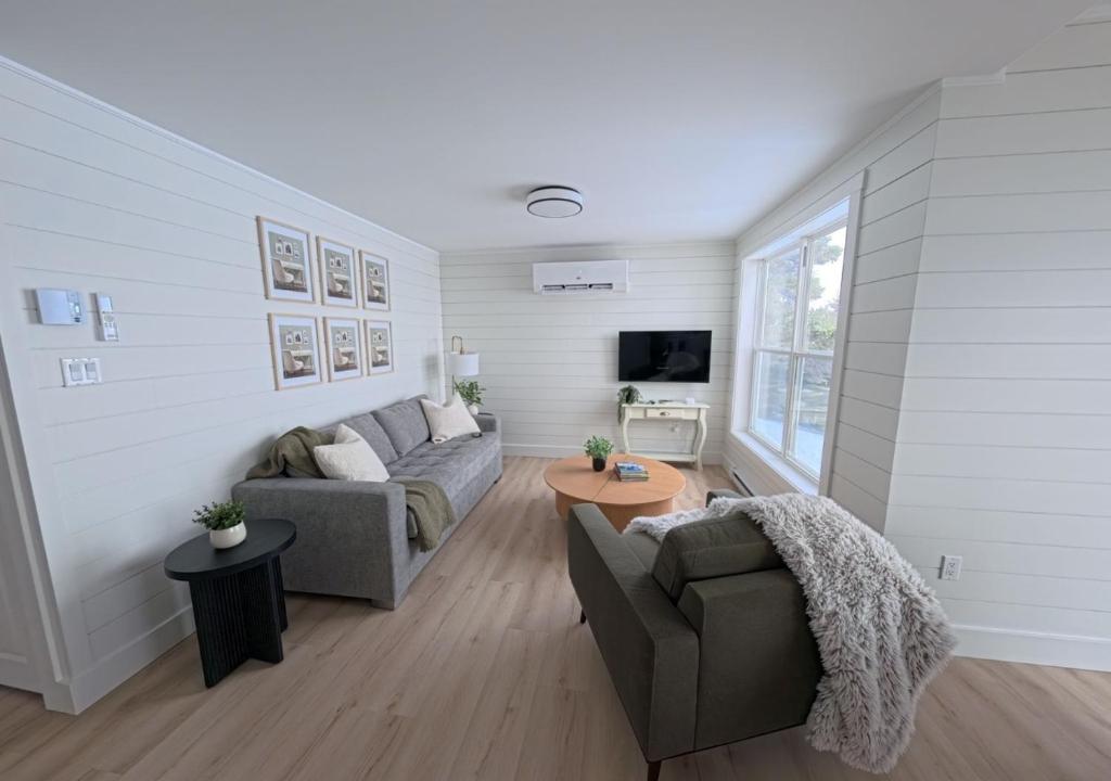 a living room with a couch and a table at Saltwater Steeple in Port Saunders