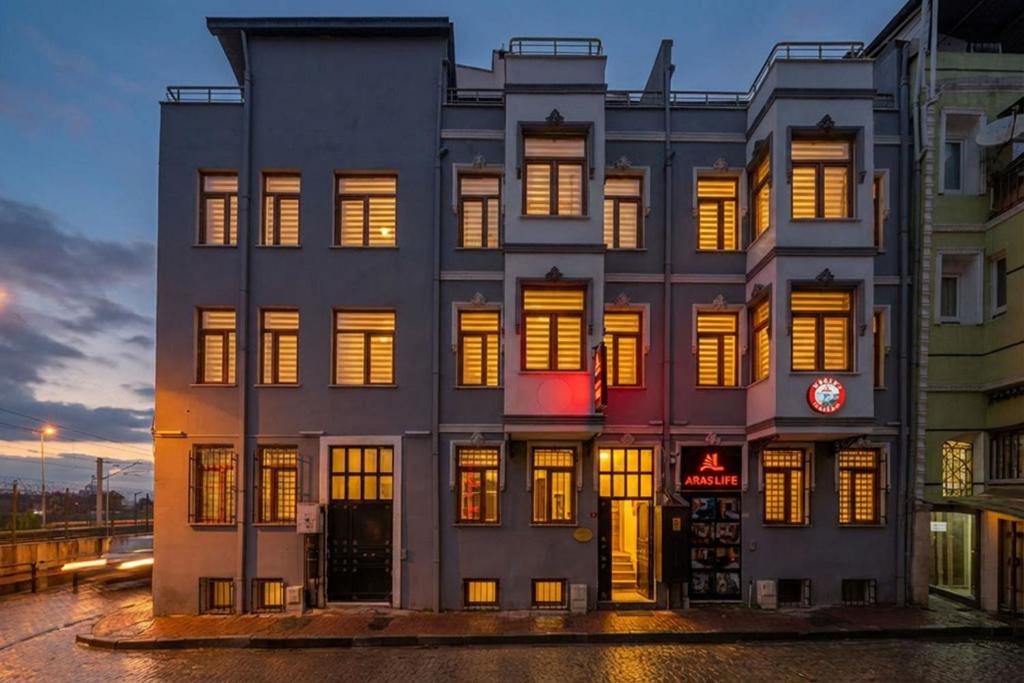 a building with lit up windows in a city at Aras Life Hotel in Istanbul