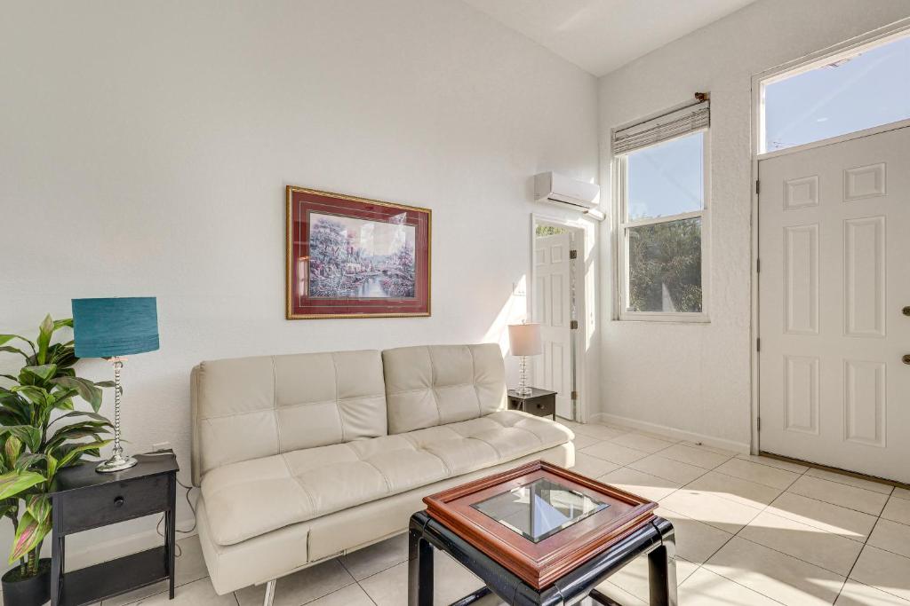 a living room with a couch and a table at Near Apollo Beach! Bright Apt w/ Essentials in Ruskin