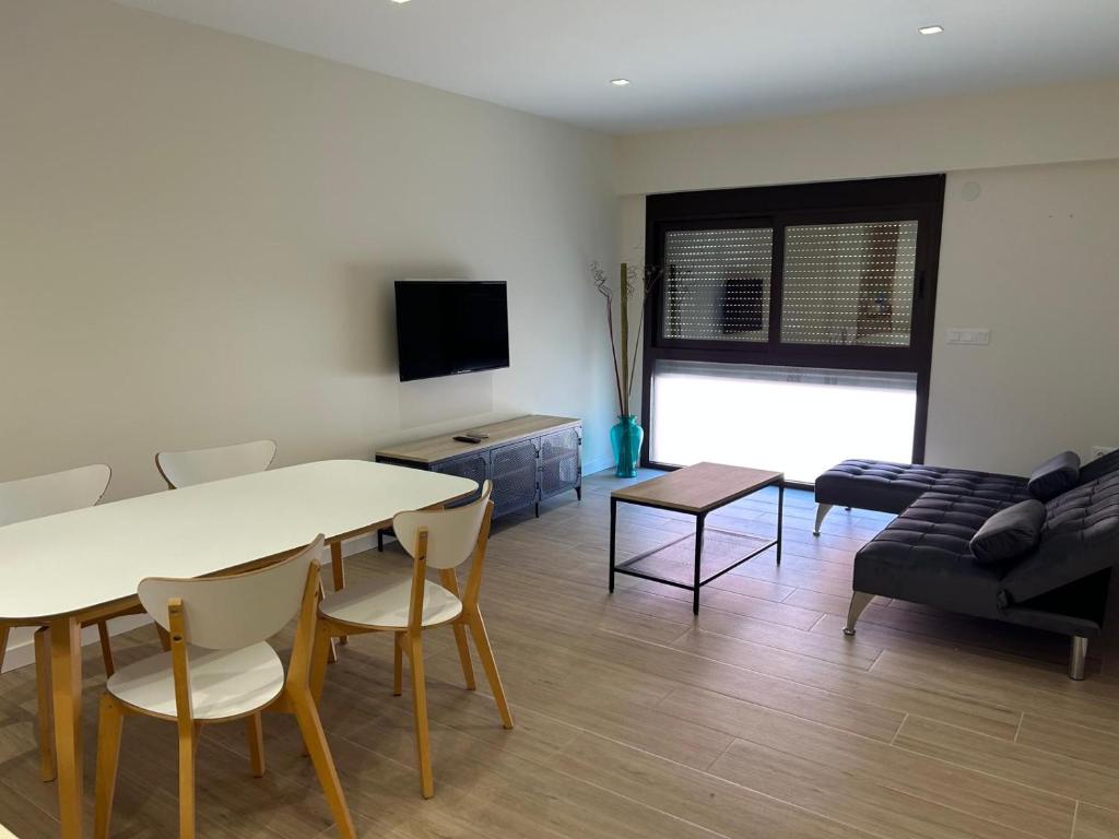 a living room with a table and chairs and a couch at Lorenzo in Benaguacil