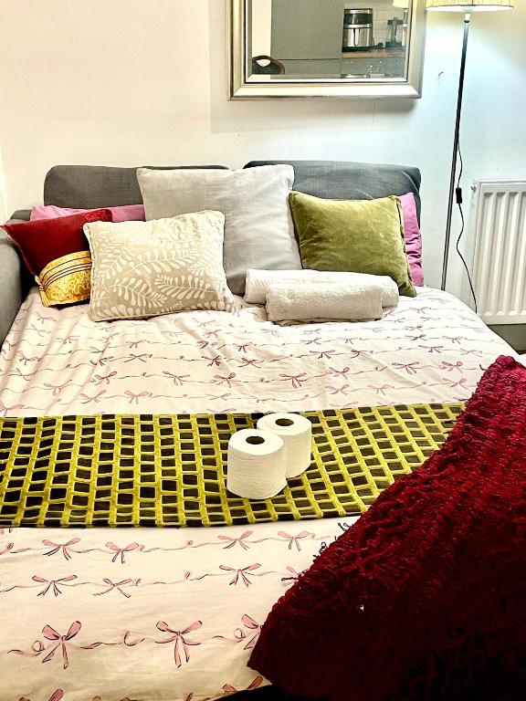 a bed with two towels and pillows on it at Studio in Edgware